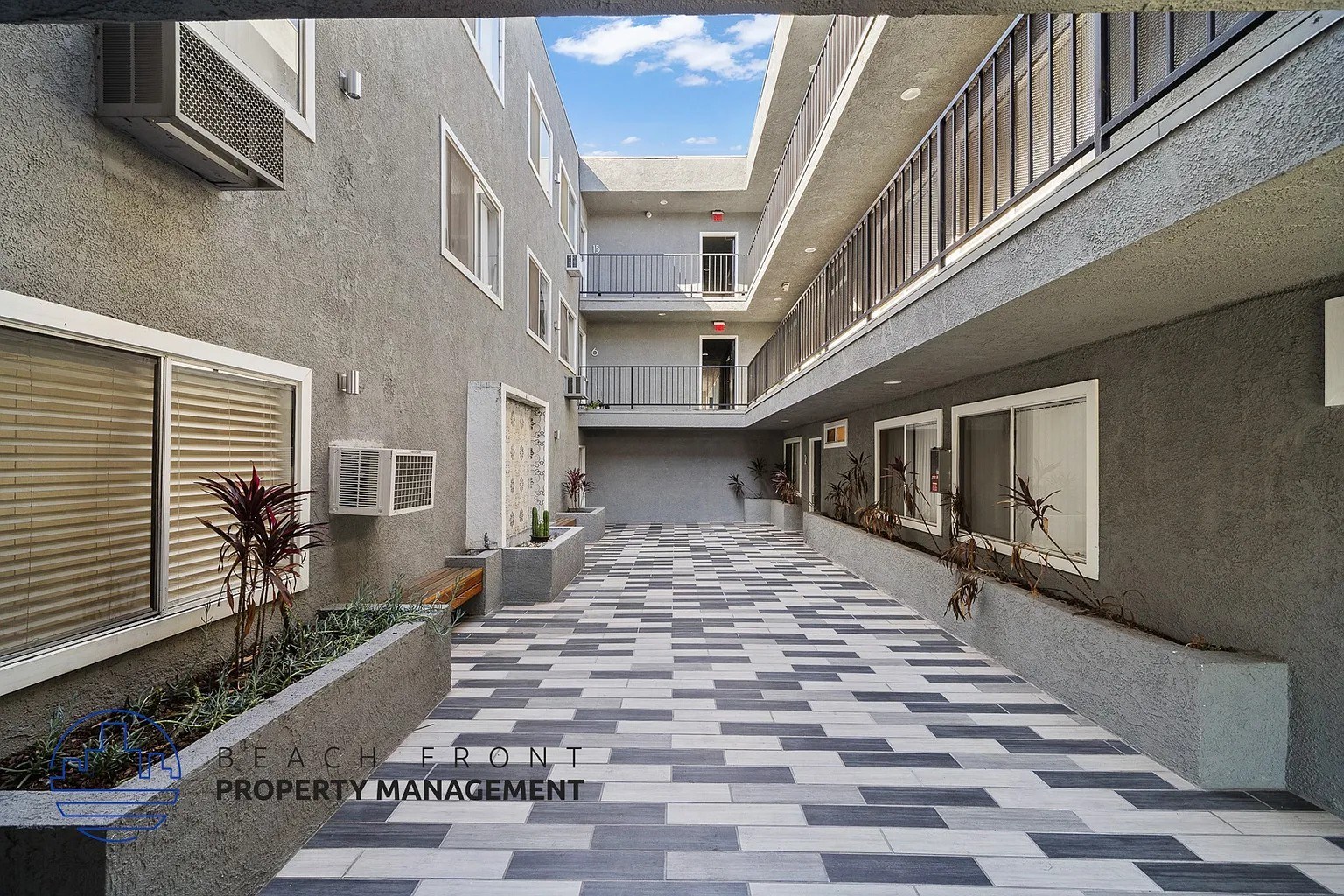 A long hallway with a tiled floor and concrete walls.